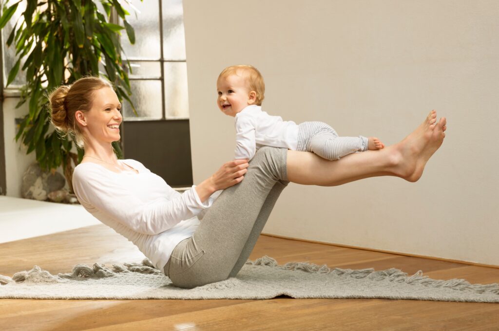 Woman balancing baby on her legs